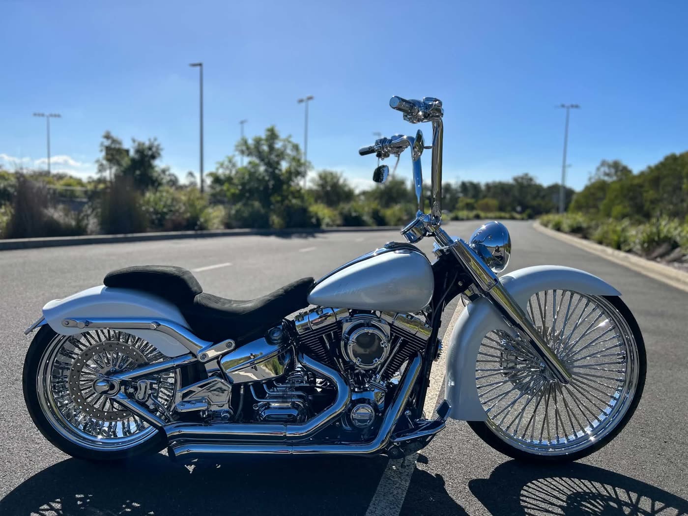 Silver Harley with big spoked wheels